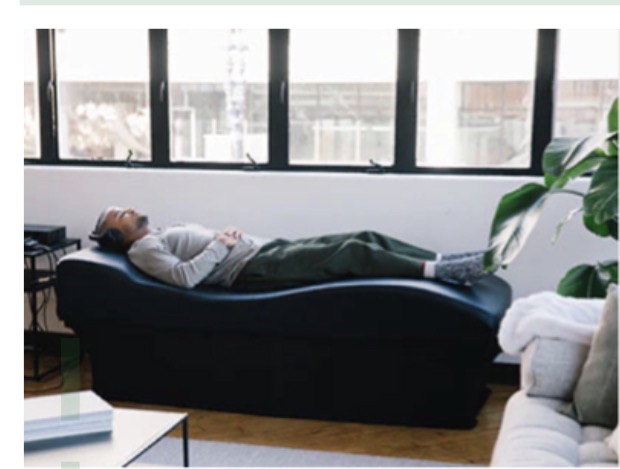 Person relaxing on a vibro-acoustical sound bed